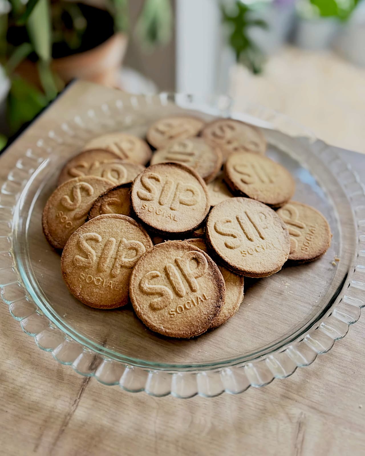 Shortbread biscuits stamped with the Sip Social logo