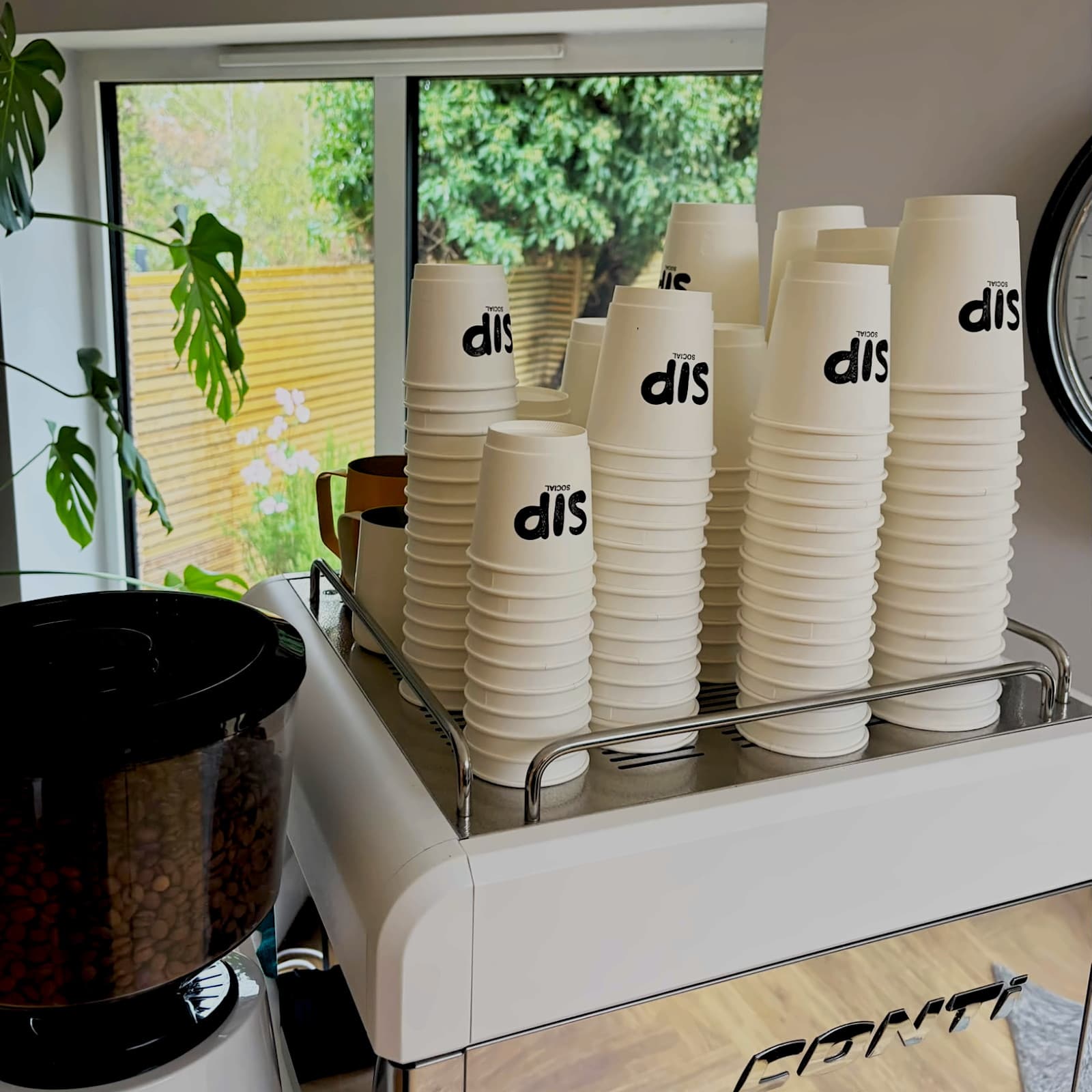 Stacks of branded Sip Social cups ready for guests