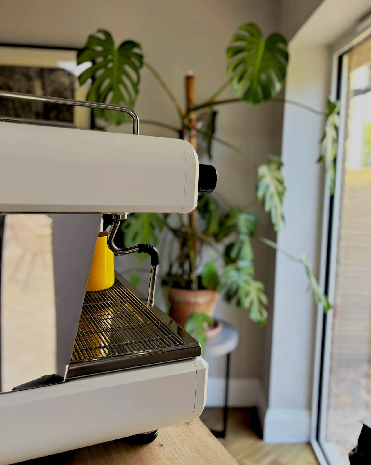 The espresso machine on the Sip Social cart beside a window