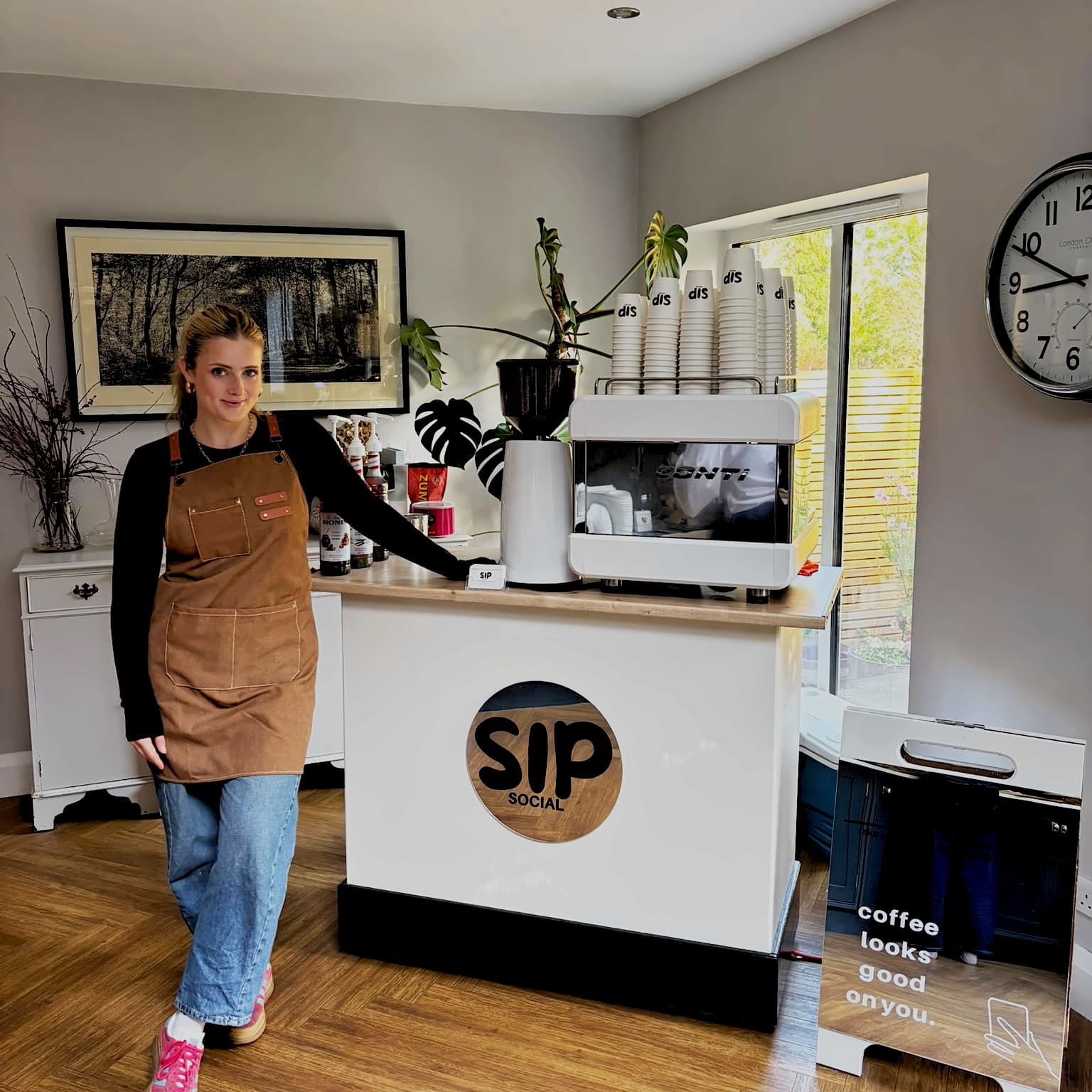 Zoe Stone standing beside the Sip Social coffee cart